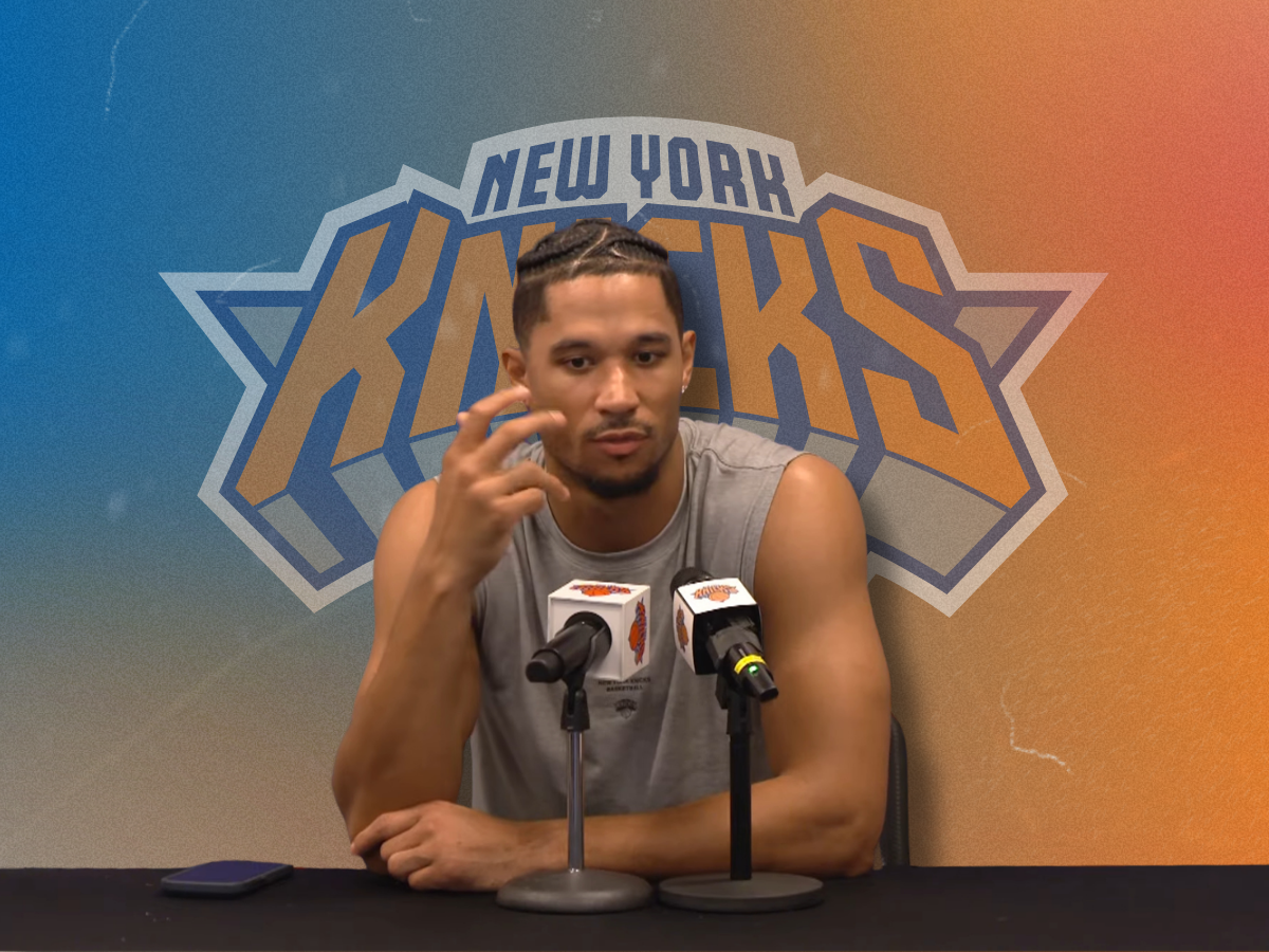 New York Knicks guard Josh Hart speaking at the training camp podium in a custom graphic breaking down his permanent Josh Hart finger injury wrap.